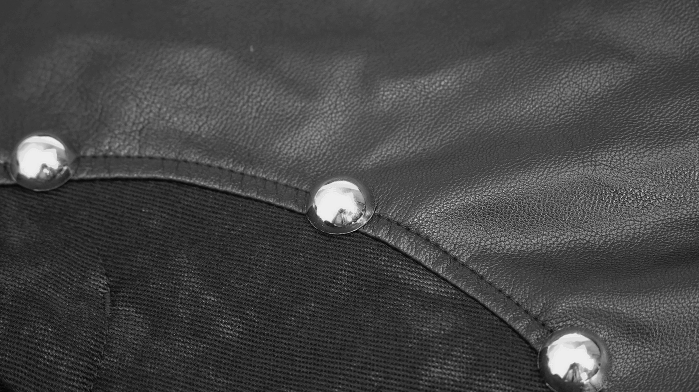 Rivet splicing detail close-up - round metal rivets connecting faux leather and fabric panels
