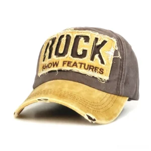 Distressed rock embroidery gothic baseball cap front three-quarter view, brown body with yellow faded brim and frayed rock show patch