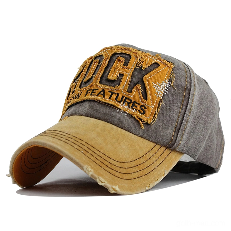 Faded yellow brim distressed denim cap front three-quarter view with ROCK embroidery patch and worn texture