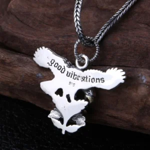 Back of gothic eagle rose pendant showing 925 hallmark stamp, vintage silver texture, and intricate engraved details on dark wood background