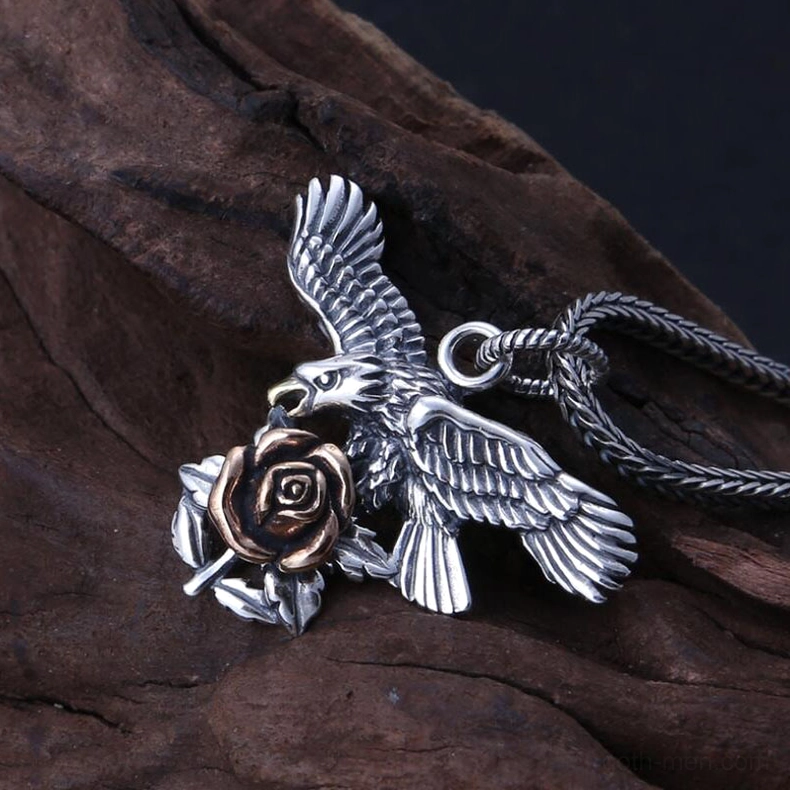 Left oblique view of gothic silver rose eagle pendant highlighting realistic carved eagle and delicate rose relief sculpture