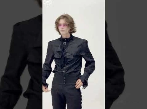 Partial front view of gothic ruffled men's shirt with tailored stand collar and jacquard weave detail