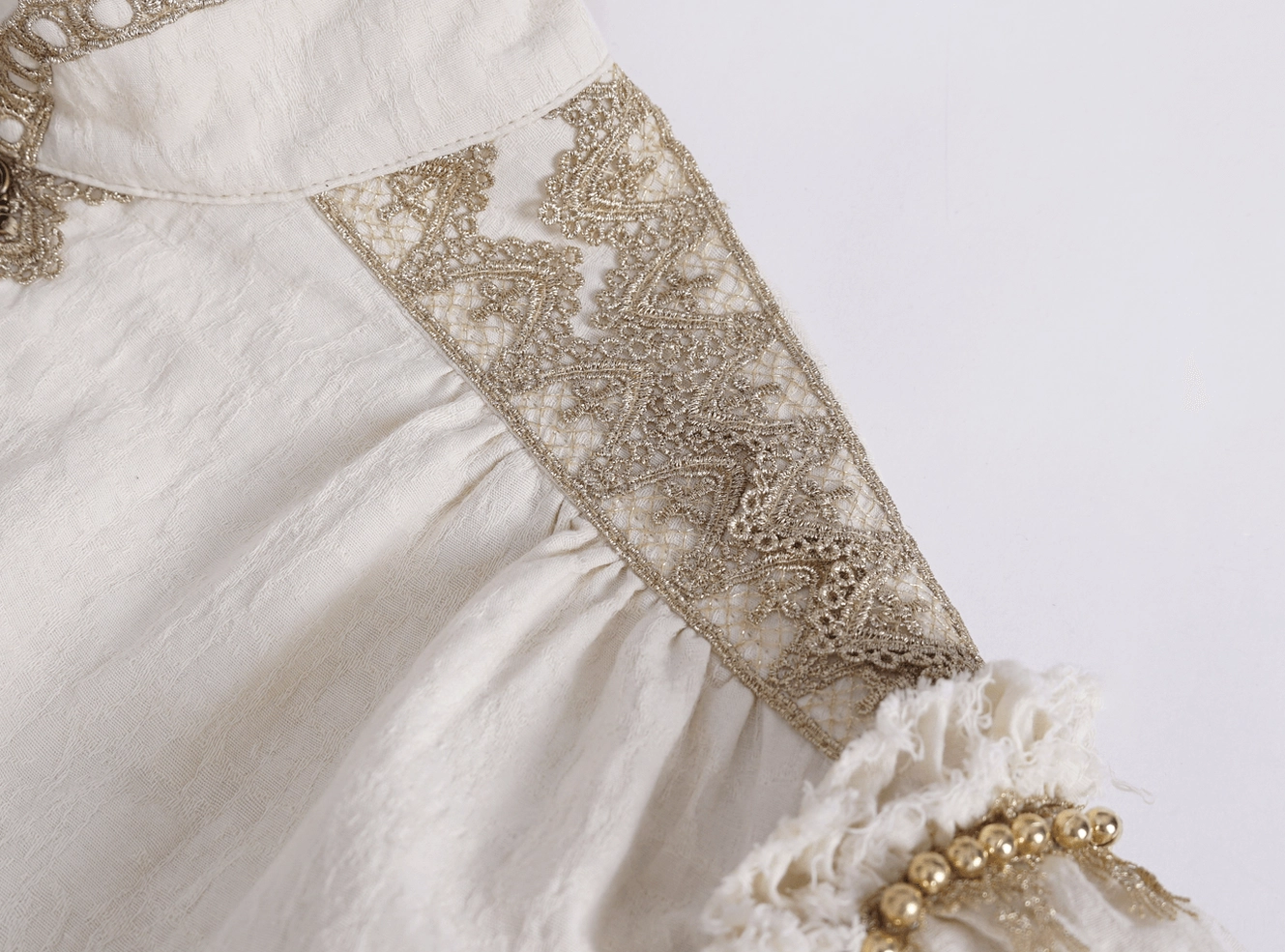 Shoulder and dramatic ruffle detail with lace appliqué and beaded accents