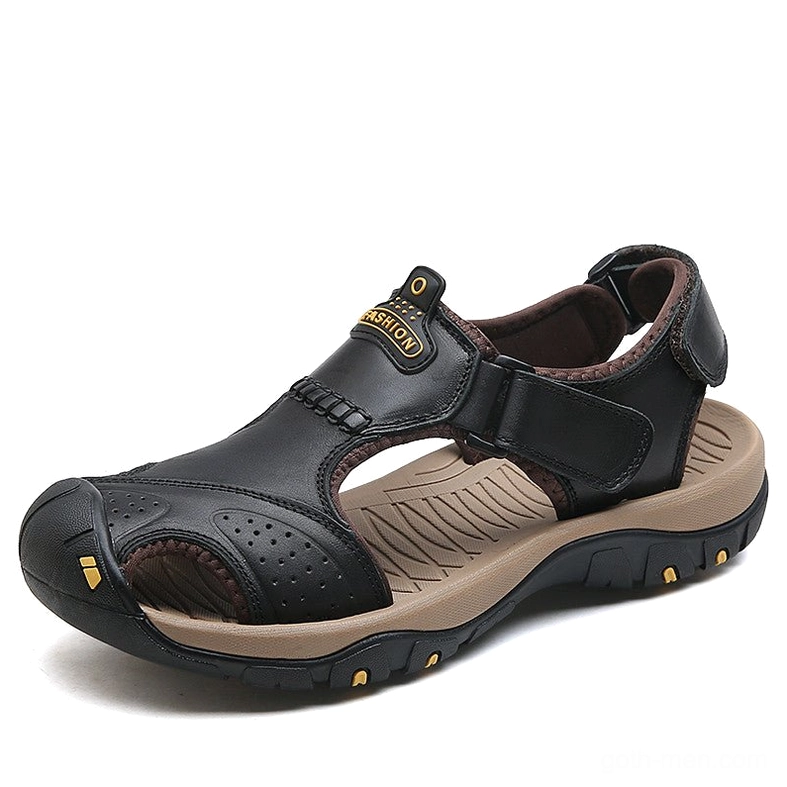 Black smooth leather gothic sandals with branded front tab and yellow outsole accents