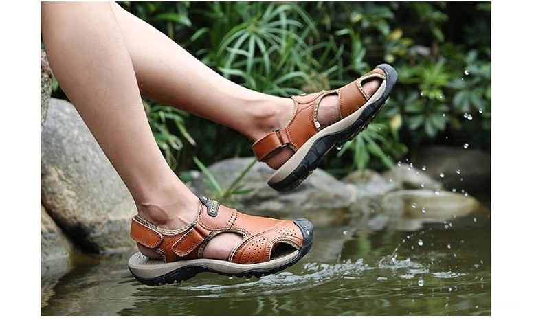 Black perforated gothic sandals top-down view showcasing strap architecture and design