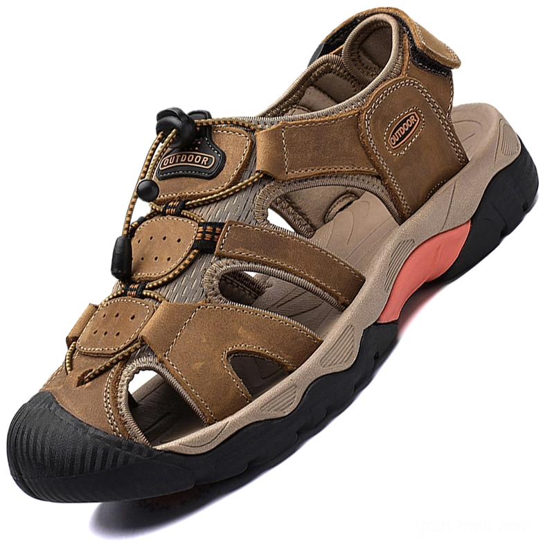 Tan brown gothic leather sandals for men low angle view with pink outsole accent