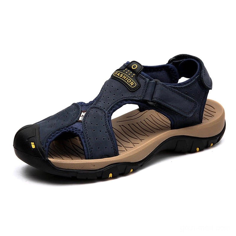 Navy blue leather gothic sandals with hook-and-loop fastener and yellow outsole accents