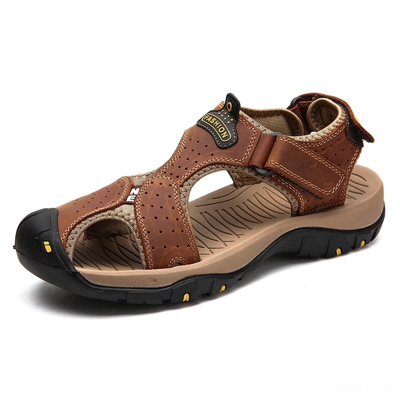 Tan brown leather gothic sandals with perforated upper and branded front detail