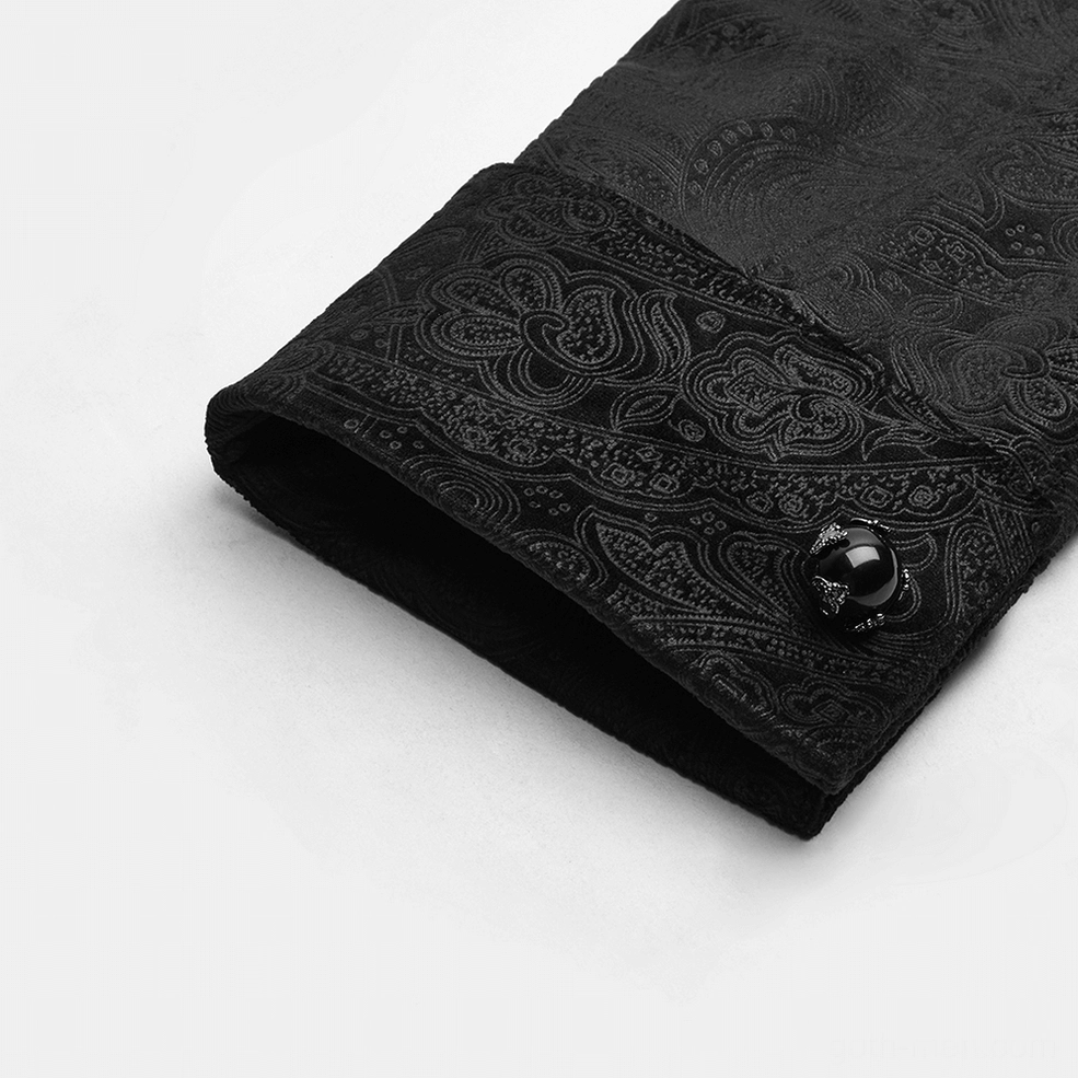 Close-up of decorative gemstone cuff button on black gothic shirt sleeve with paisley jacquard detail