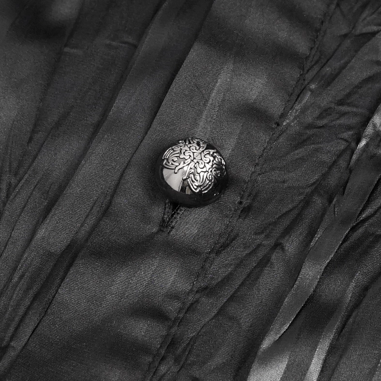Close-up of embossed metal button and vertical wrinkled satin fabric texture from men's gothic ruffled shirt