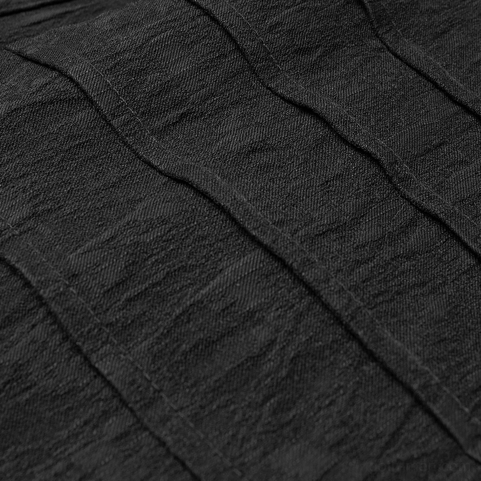 Black gothic shirt fabric and seam detail - close-up stitching showing jacquard texture and construction quality