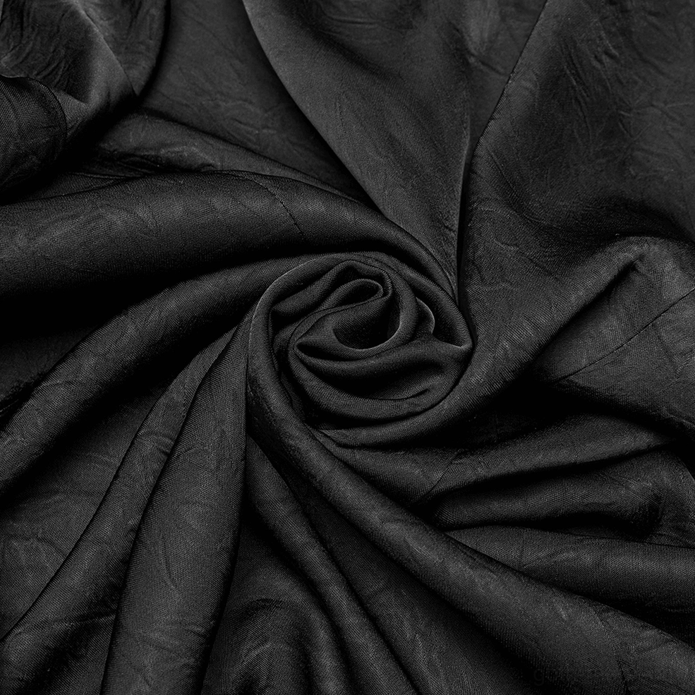 Black woven fabric texture close-up showing pleated wrinkle pattern and soft polyester weave