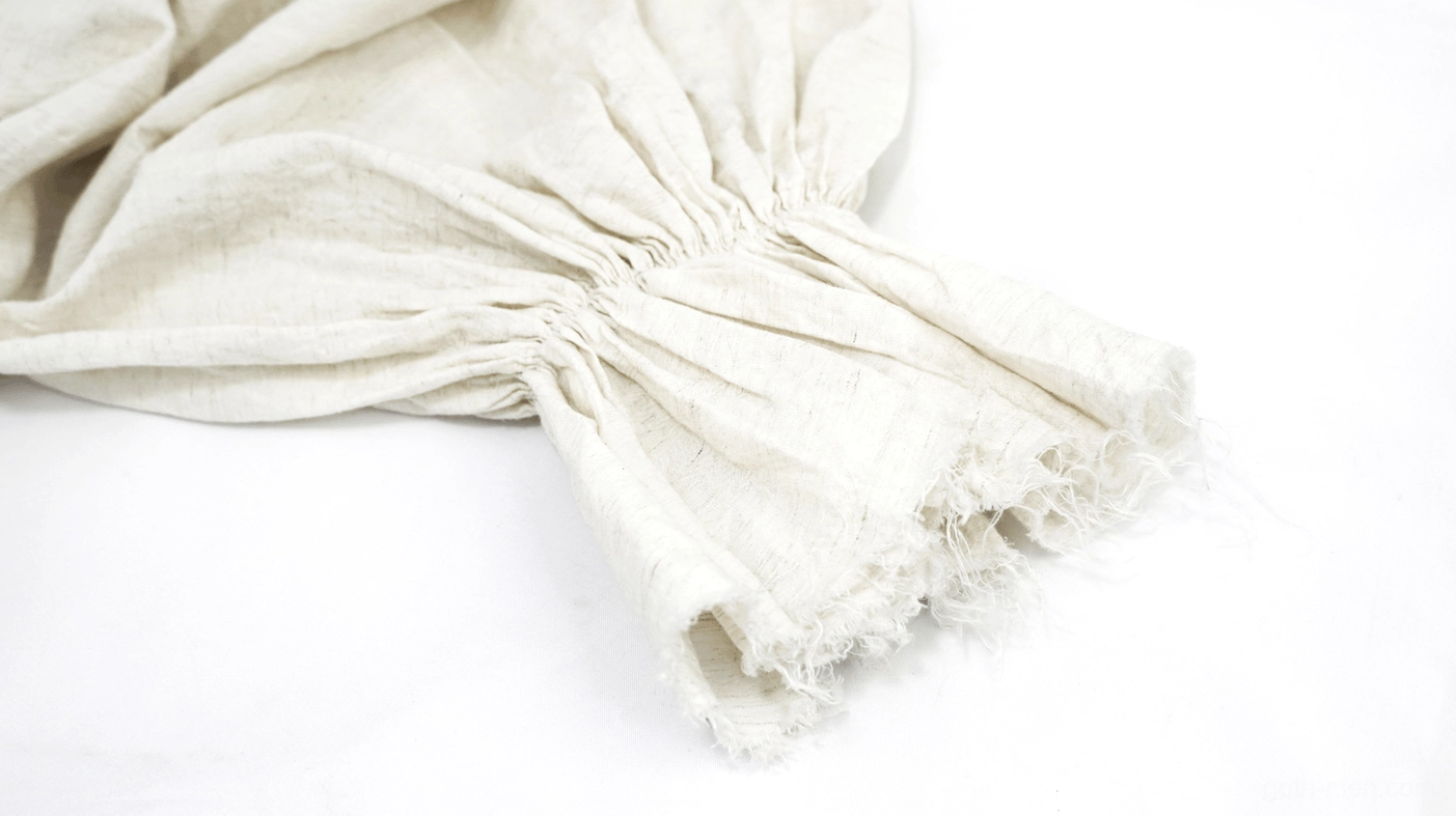 Close-up detail of gothic shirt cuff with frayed raw edge and gathered flared construction