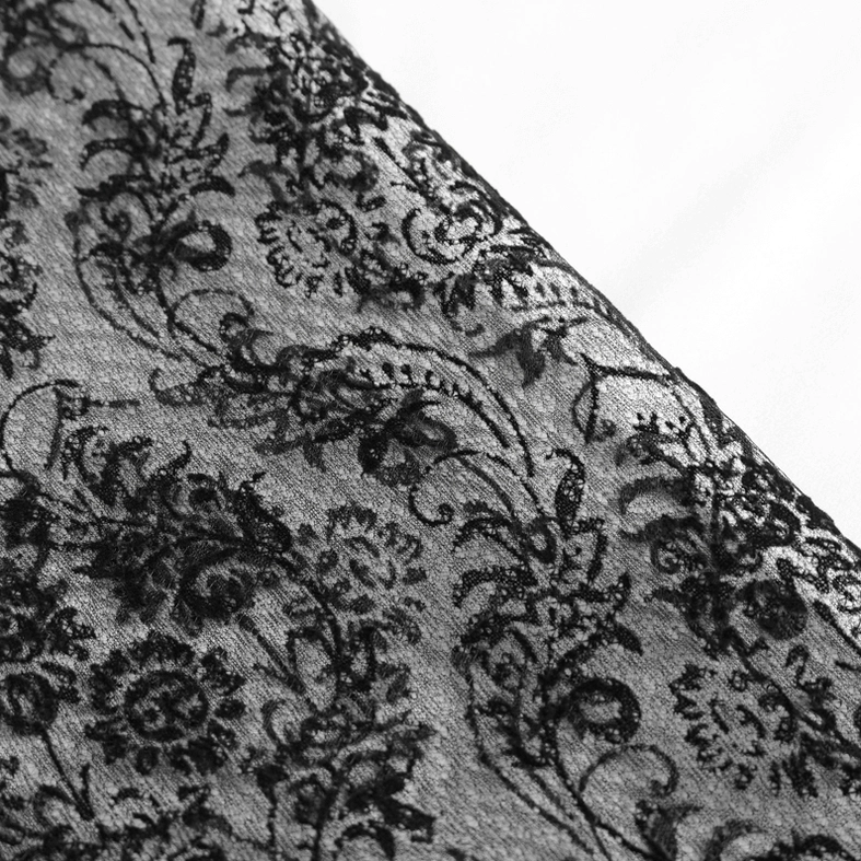 Macro close-up of vintage floral lace fabric texture used on gothic shirt sleeves