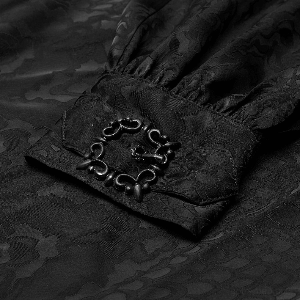 Detailed view of black gothic shirt decorative metal buckle fastener and gathered sleeve cuff