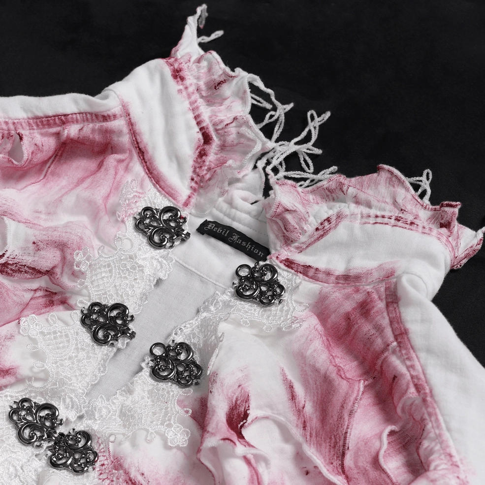 Close-up detail of gothic ruffle shirt metal clasp buttons, lace trim, and raw frayed edges