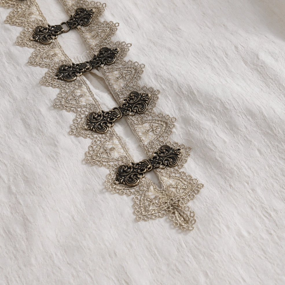 Ornate metal toggle fasteners and vintage lace trim front placket detail
