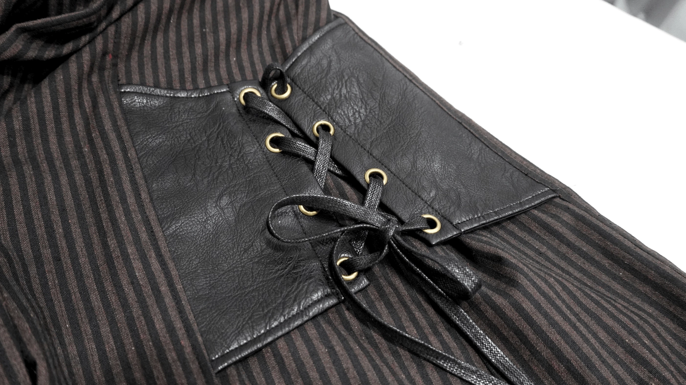 Close-up detail of black PU leather side panel with bronze lace-up fasteners on gothic shirt
