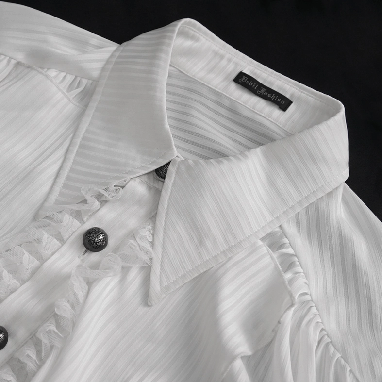 Close-up of white gothic shirt ruffled collar and vintage dark metal buttons with brand label, studio shot