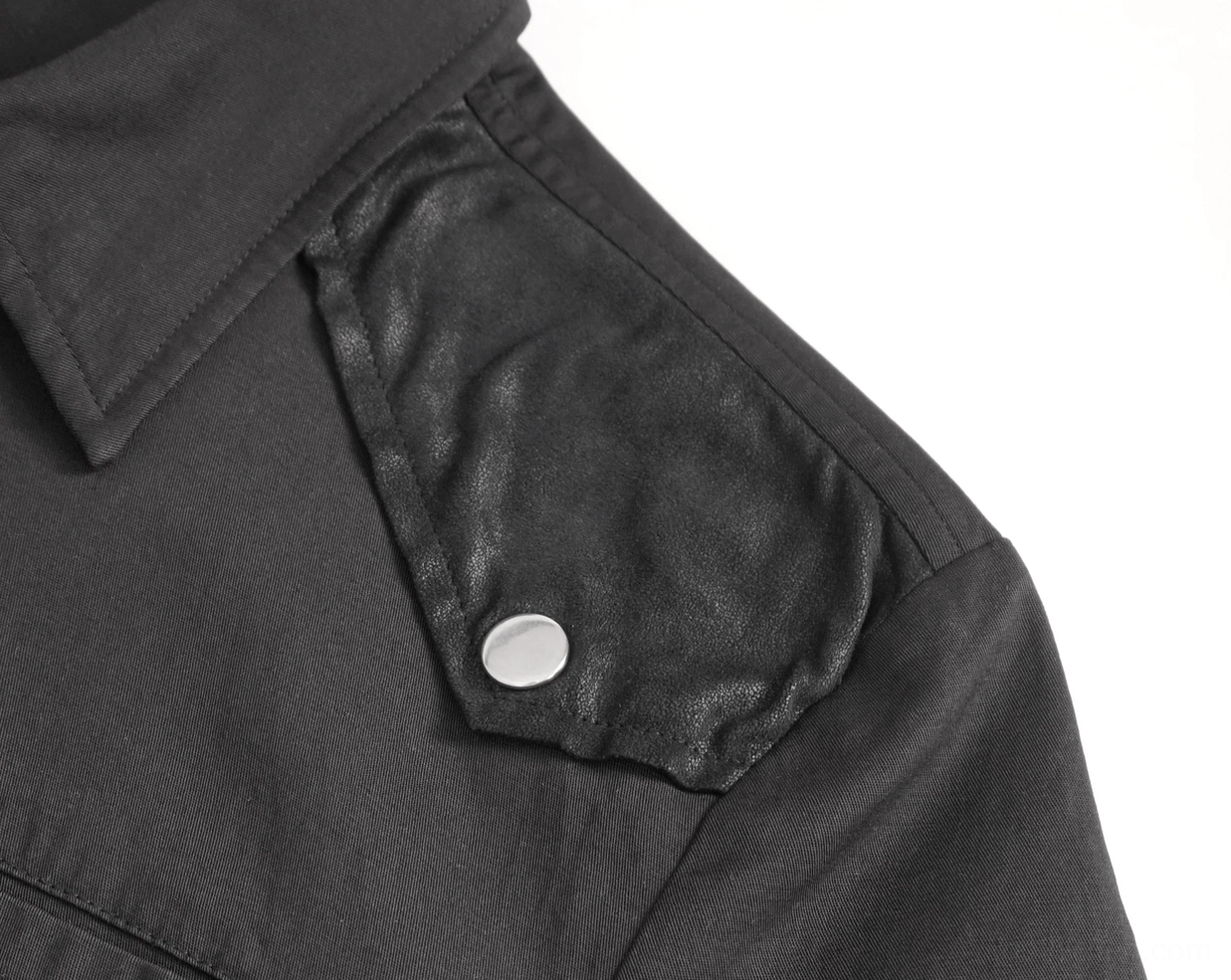 Shoulder epaulet detail of black gothic punk shirt showing imitation leather patch and single metal stud fastening