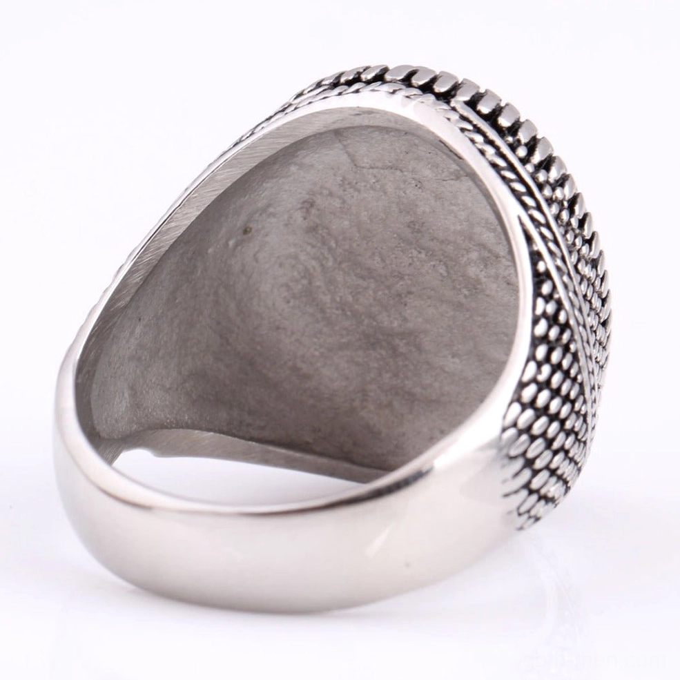 Vintage signet ring top-down inner view showing embossed pattern on stainless steel band
