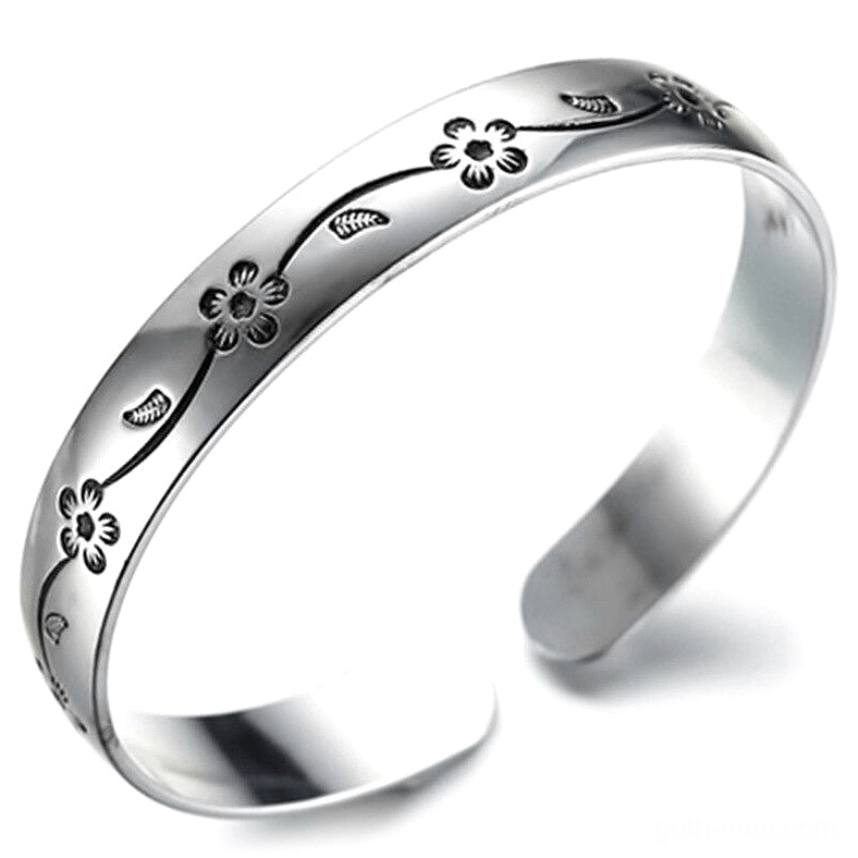 Dark floral silver gothic bangle bracelet with oxidized vine engraving, oblique side view showing vintage patina effect