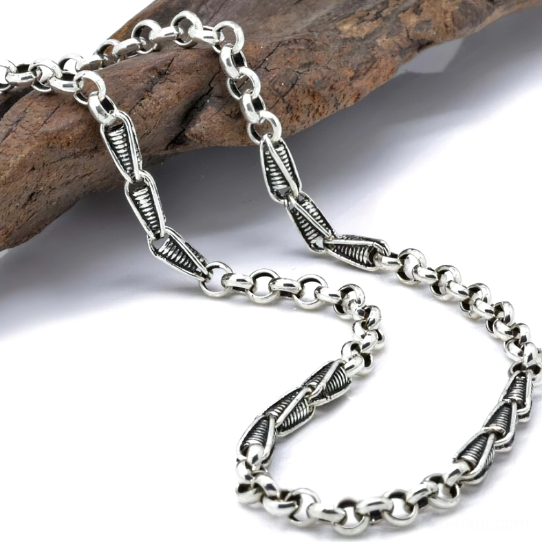 Vintage twisted sterling silver link chain necklace with antiqued patina and fishhook clasp, displayed on wooden surface with gothic styling