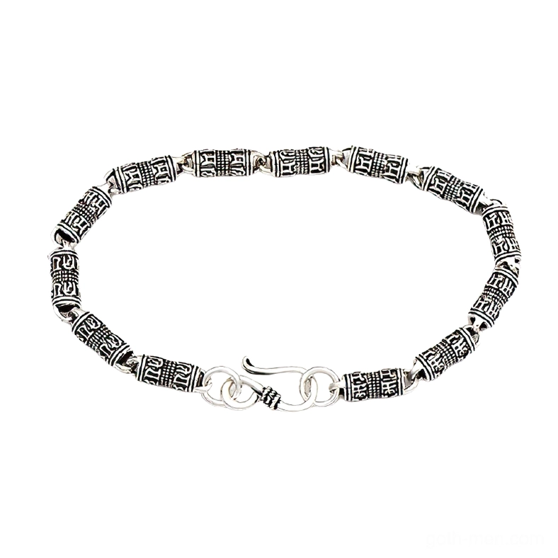 Gothic silver engraved cylindrical bracelet with occult symbols in aged sterling silver, overhead flat lay view with hook clasp