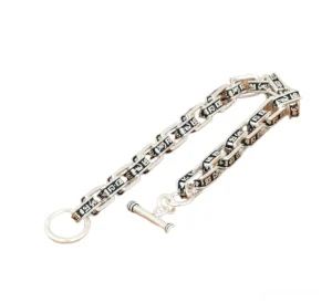 Sterling silver square link bracelet with engraved mantras, side flat lay showing toggle clasp and link details