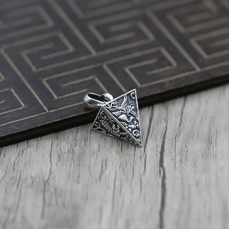Back view of sterling silver pyramid pendant showing floral and animal embossed designs with bail loop attachment