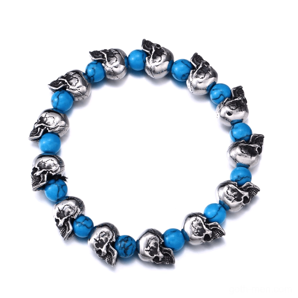 Silver skull bead elastic gothic bracelet with blue stone accents, flat lay top view on white background