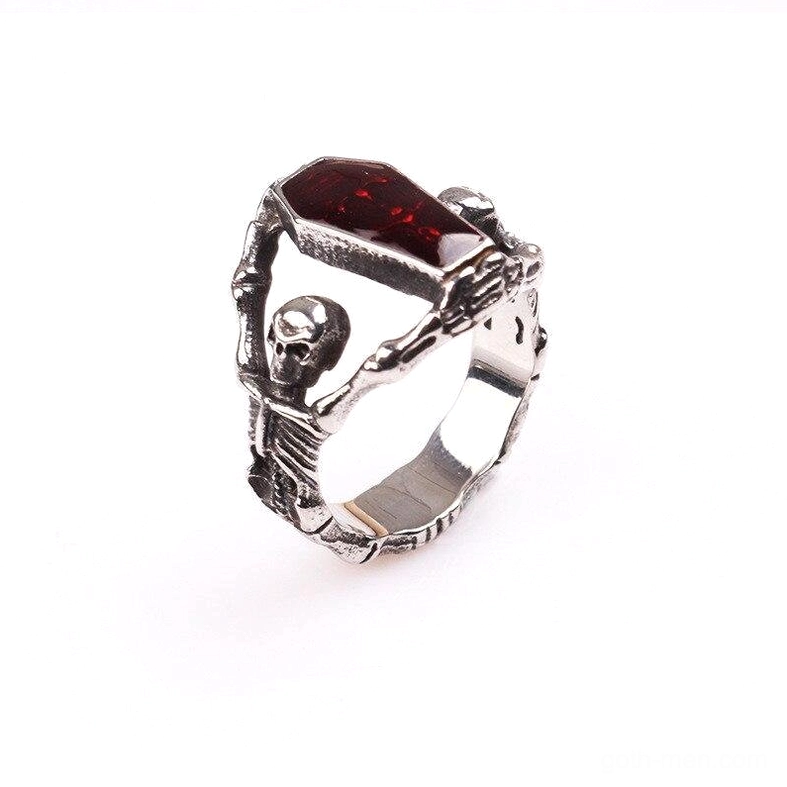Detailed gothic skeleton ring showing vintage silver finish and red inlaid coffin-shaped stone - side oblique perspective