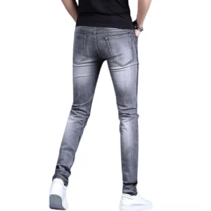 Back view of gothic embroidered stretch denim jeans showing classic pocket design and full-length silhouette