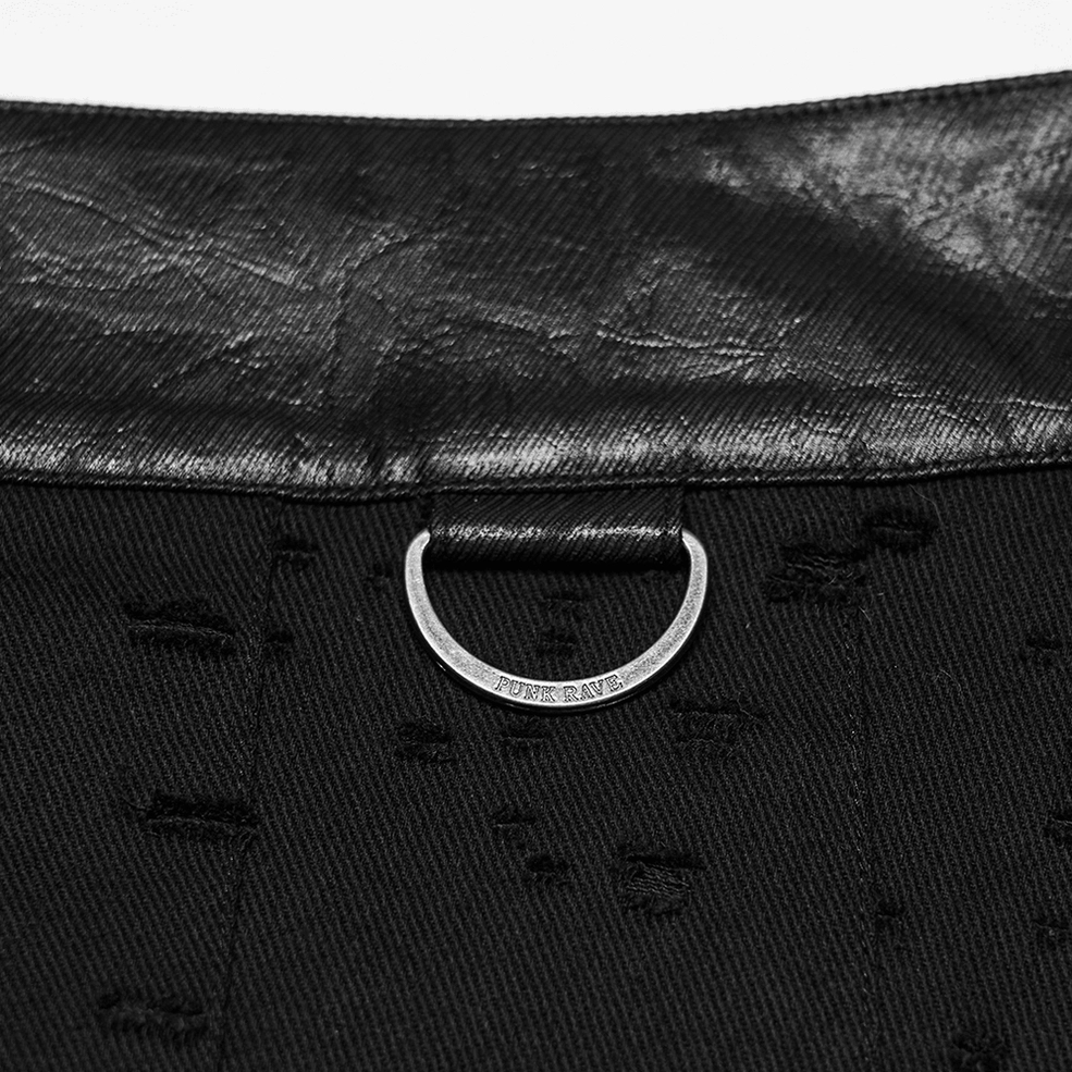 Extreme close-up of perforated denim fabric showing hole-punching detail and metal D-ring hardware