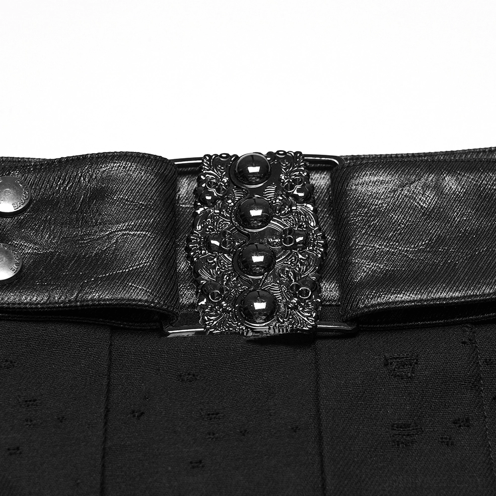 Close-up detail of ornate carved metal buckle and studded leather waistband hardware