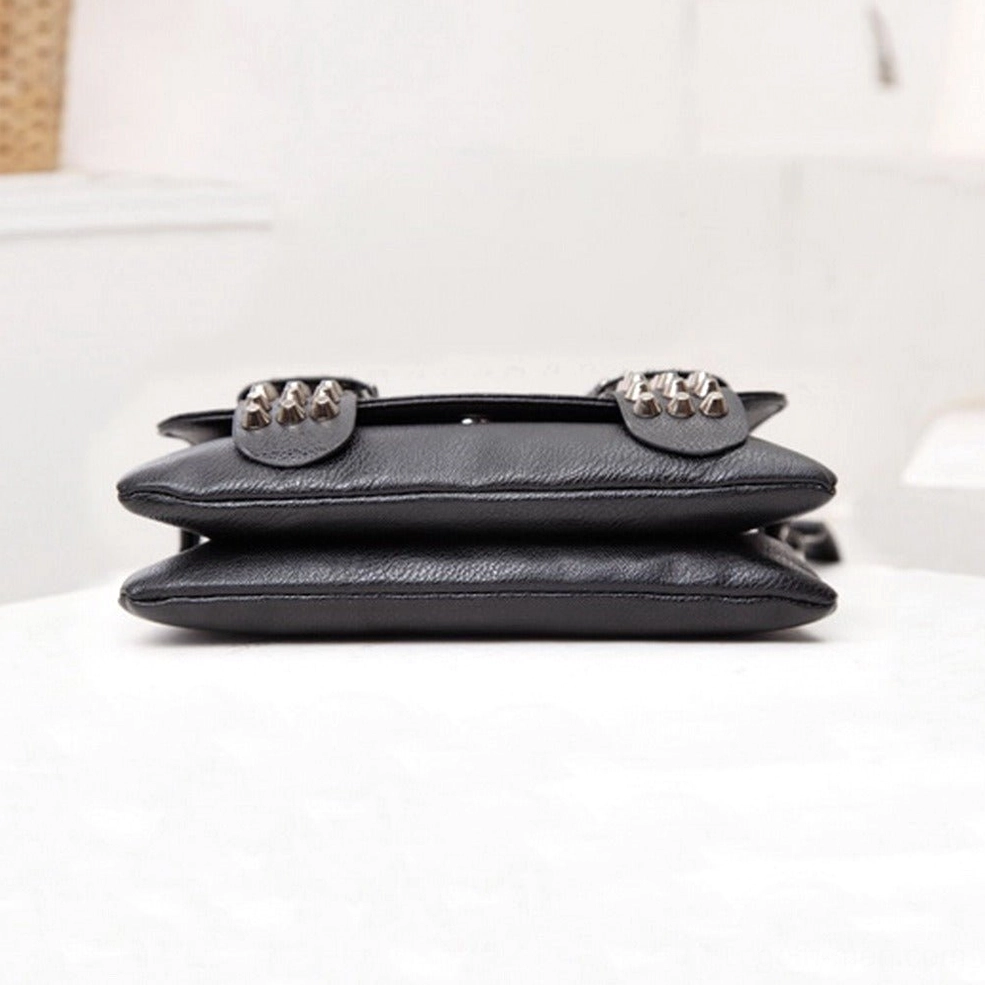 Top-down flat lay view of black gothic shoulder bag showing rivet-decorated flap slim leather construction and metal chain strap