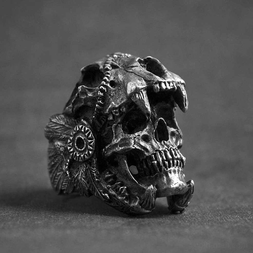 Vintage black metal gothic warrior skull ring with totem decorations and intricate relief carvings, left side view