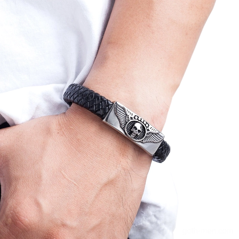 Male model wearing black winged skull gothic leather bracelet on wrist demonstrating casual daily wear styling