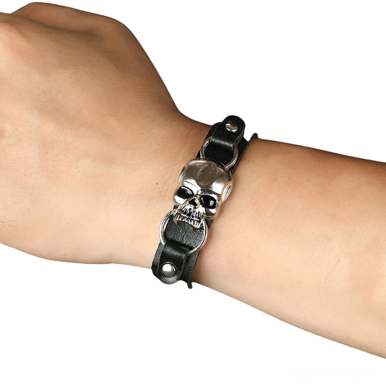 Gothic skull leather bracelet worn on wrist, side view showing adjustable buckle and fit