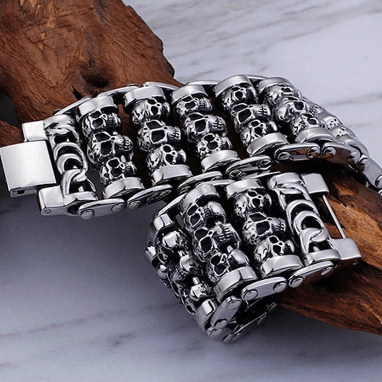 Two silver gothic skull chain bracelets stacked together showing fold clasp and chain detail