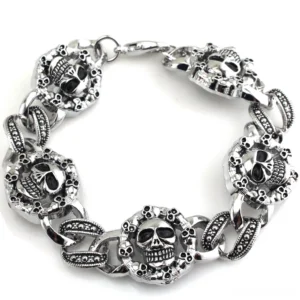 Gothic double skull stainless steel bracelet flat lay top view showing interlocking skull link chain design in antique silver finish
