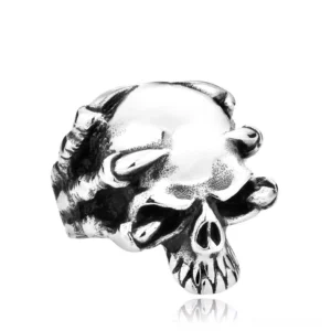 Polished silver gothic skull claw ring with skeletal claws wrapped around skull head, front three-quarter view showing intricate design details and bone-like finish