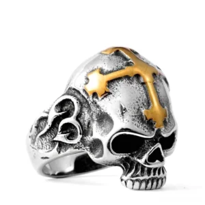 Silver-tone stainless steel skull cross ring with gold accents, front view showing detailed carved skull face with prominent cross on top