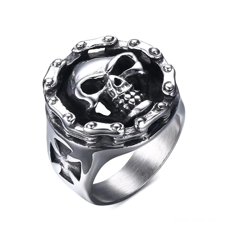 Gothic skull cross stainless steel biker ring with studded frame, top-front view showing detailed bone relief and cross cutout design