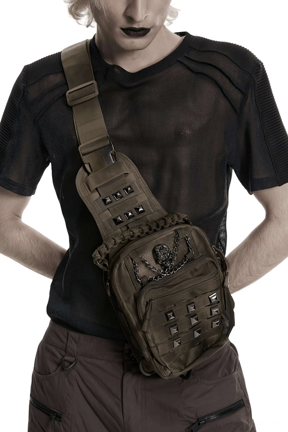 Front wearing view of gothic skull pyramid stud crossbody backpack on male model in dark studio setting