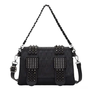 Skull embossed gothic crossbody bag front flat view with double riveted straps, pure white background