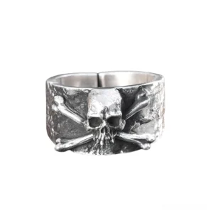 Adjustable sterling silver skull and crossbones gothic ring front view flat lay showing textured band design