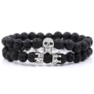 Gun-black gothic skull crown beaded bracelet with volcanic lava stone beads - dark alternative jewelry flat lay