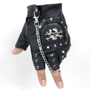 Black gothic half-finger gloves with metal skull emblem and pyramid rivets, flat lay front view showing detailed skull design