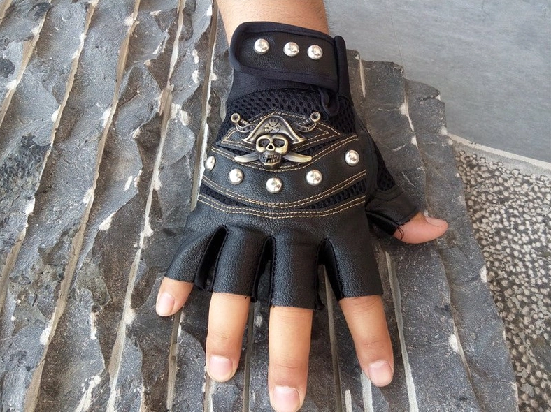Gothic skull rivet half-finger leather gloves detail shot showing precision rivet placement and mesh construction